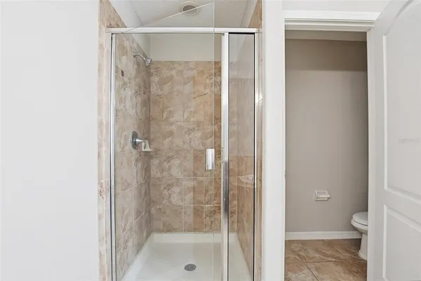 a bathroom with a granite countertop bathtub a sink and a mirror