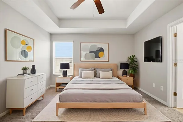 a bedroom with a bed and a flat screen tv