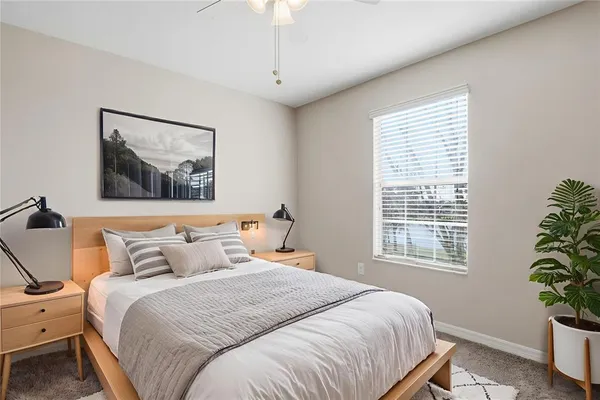 a bedroom with a bed and a potted plant