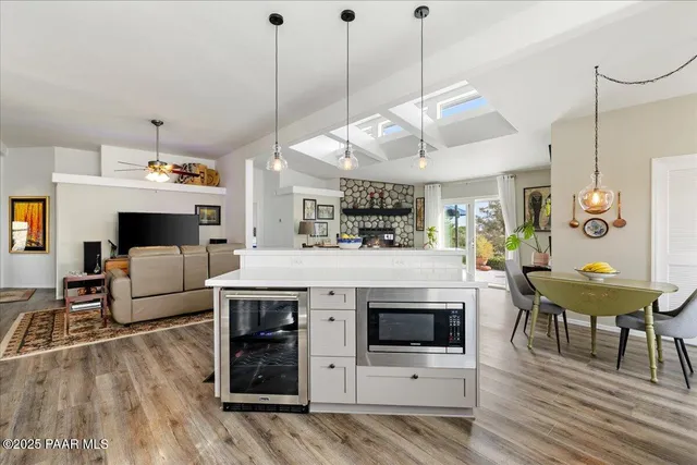 a view of kitchen and living room with wooden floor