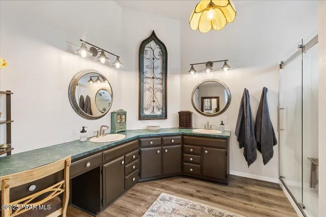 a spacious bathroom with a double vanity sink and a mirror