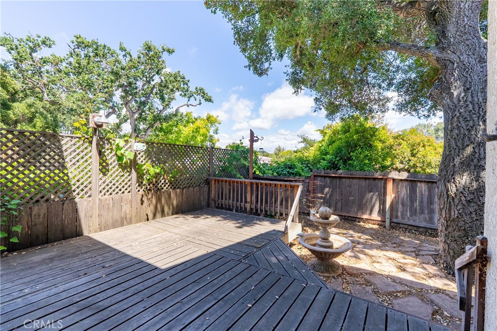 6815 Santa Lucia Road, Unit 5 Atascadero, CA 93422 - Photo 32 of 44 Stepping outside from the dining area French door, lies a wood deck that extends down to a fountain and step stone space waiting for your vision.