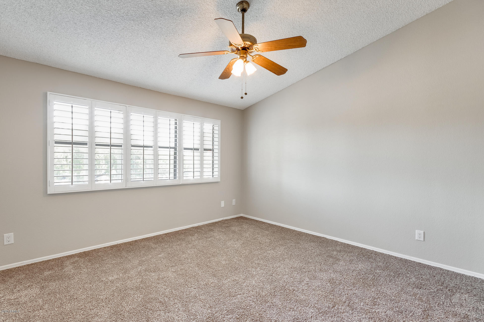 4157 East Agave Road Phoenix, AZ 85044 - Photo 4 of 33 an empty room with windows and fan