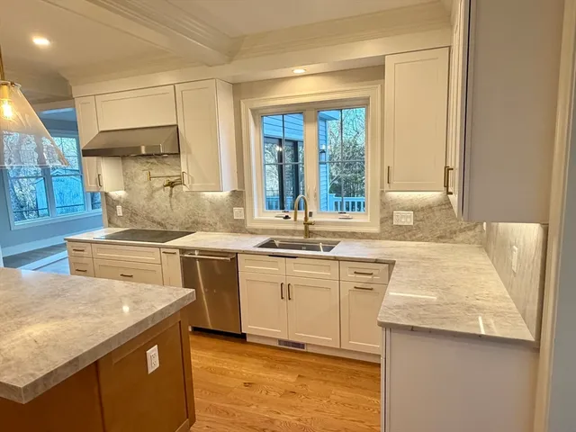 a view of a room with wooden floor and window
