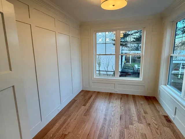 a view of a room with wooden floor and window