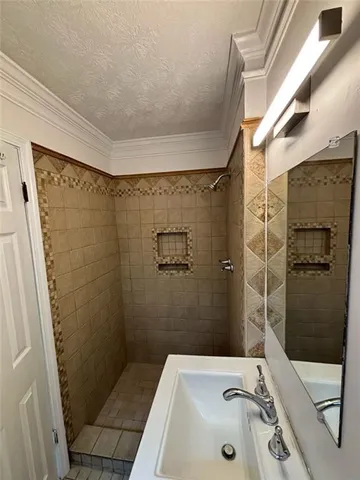 a bathroom with a sink and shower