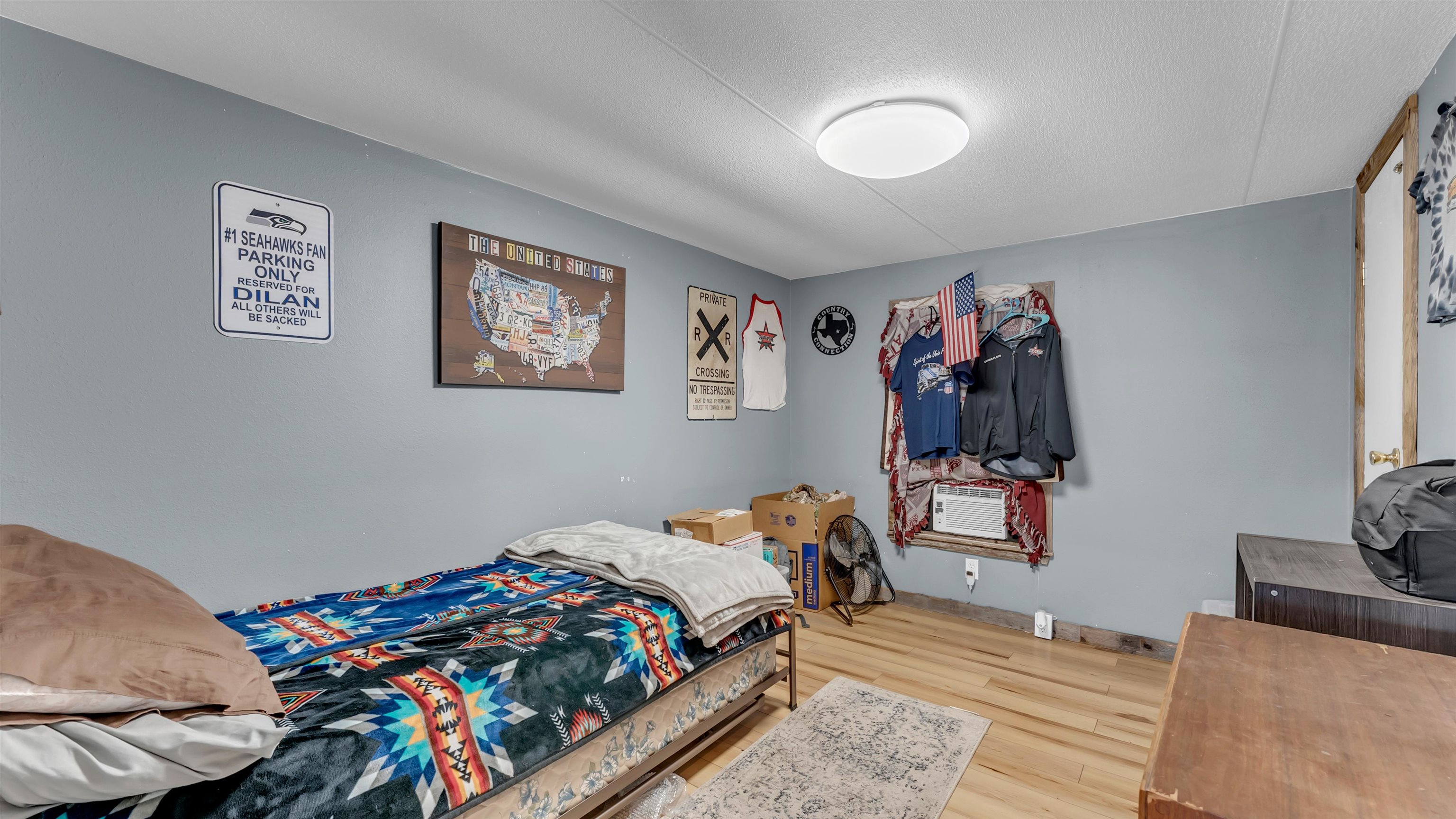 5128 West 29th Highway Bertram, TX 78605 - Photo 15 of 28 a bedroom with bed and a painting on the wall