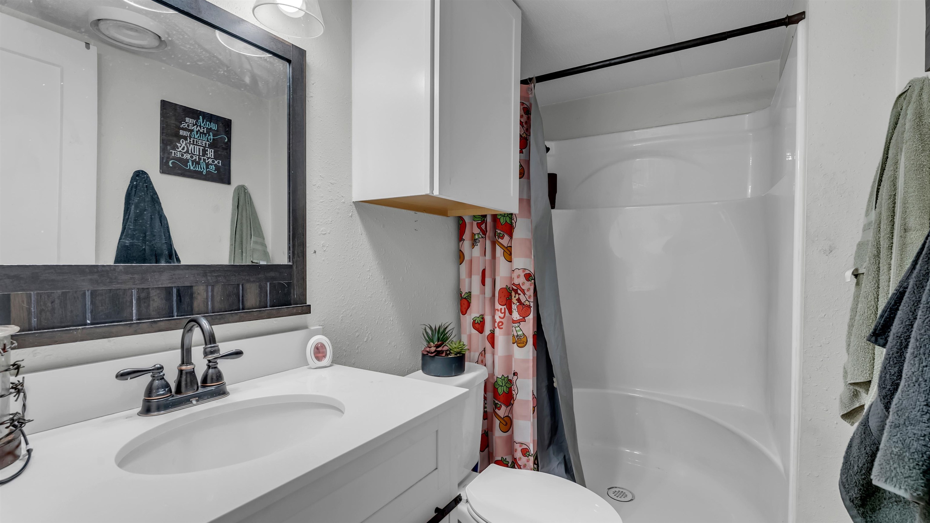 5128 West 29th Highway Bertram, TX 78605 - Photo 16 of 28 a bathroom with a sink toilet and shower