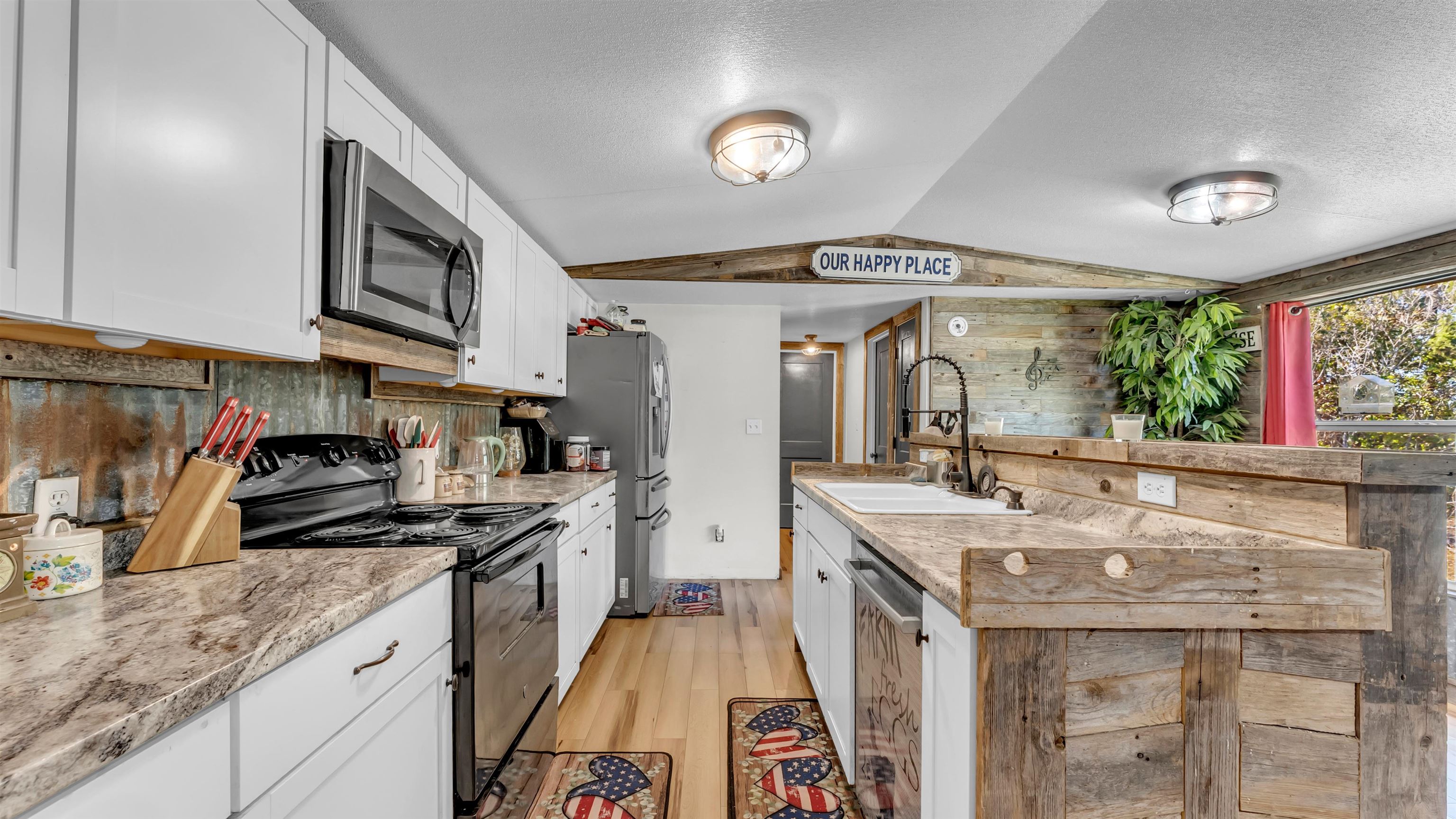 5128 West 29th Highway Bertram, TX 78605 - Photo 9 of 28 a kitchen with stainless steel appliances granite countertop a sink stove and refrigerator