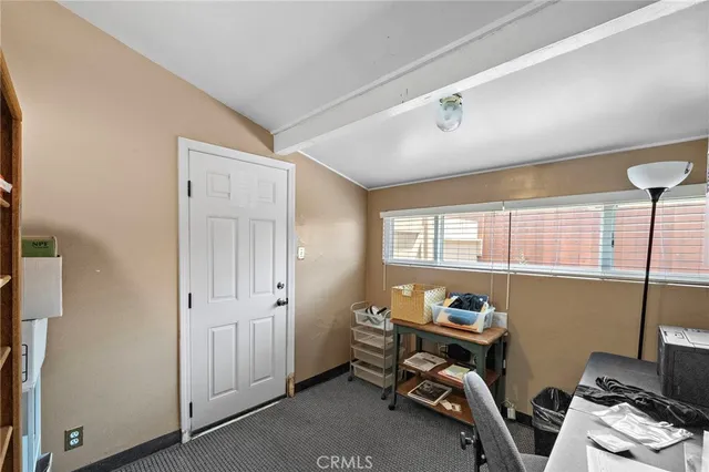 a view of a room with workspace and windows