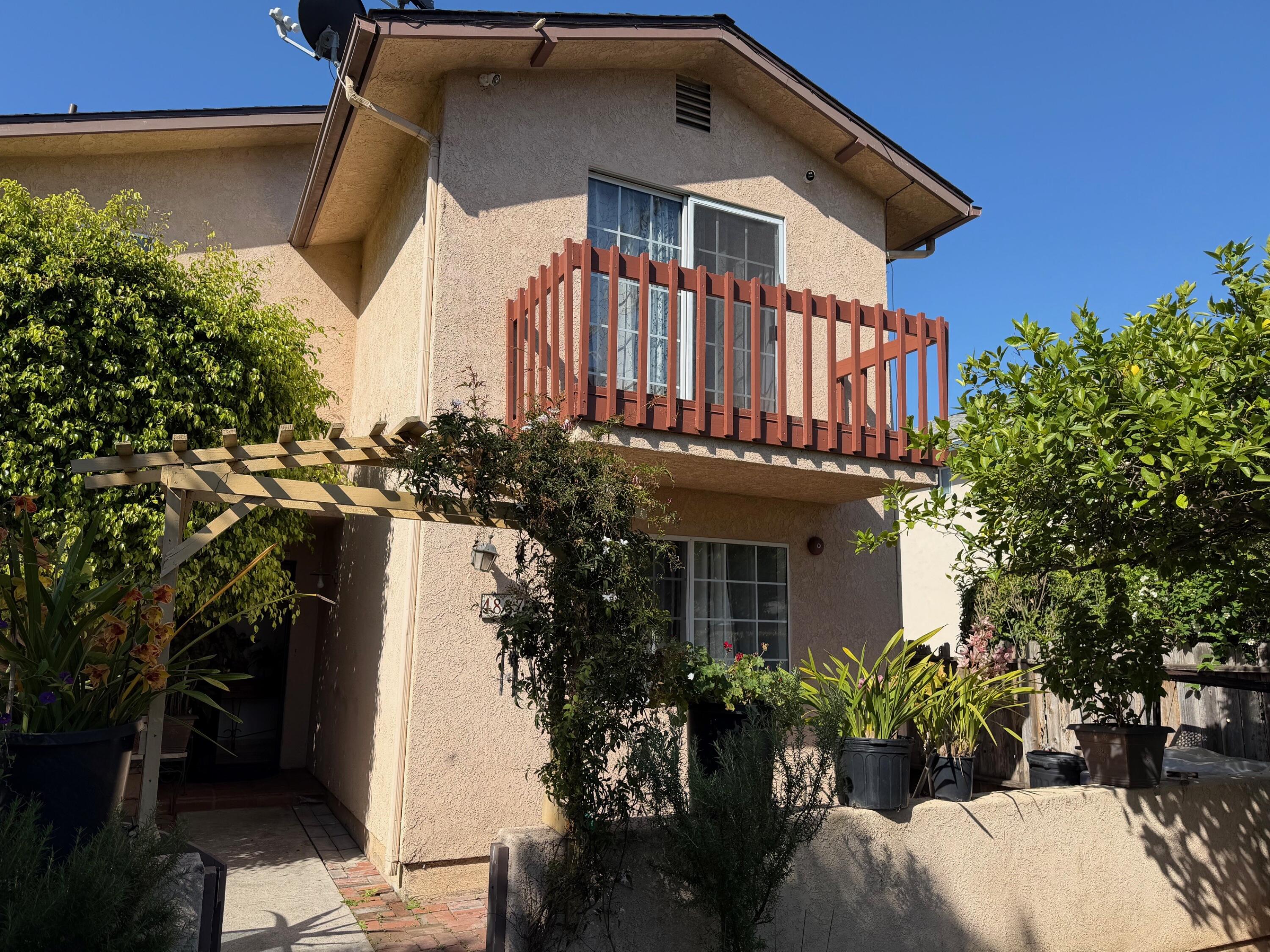 4837 7th Street Carpinteria, CA 93013 - Photo 1 of 3 a front view of a house with a garden