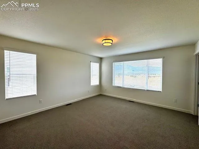 an empty room with a empty space and windows