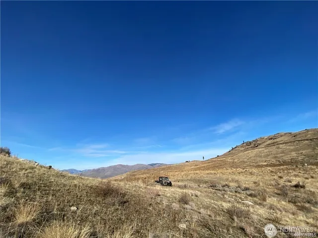 a view of a large mountain with mountains in the background