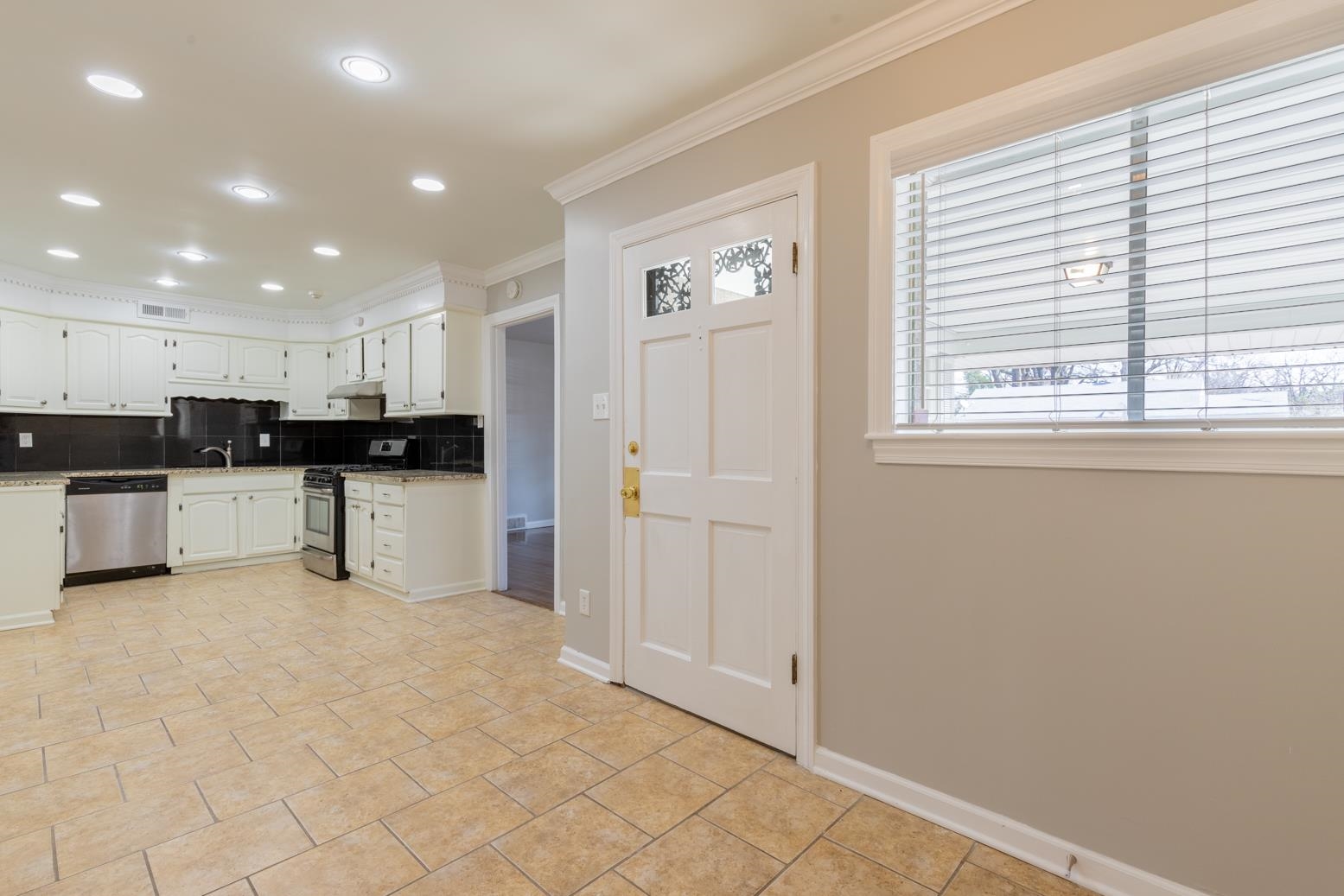 1511 Raymore Road Memphis, TN 38117 - Photo 12 of 21 a view of kitchen with refrigerator cabinets and window