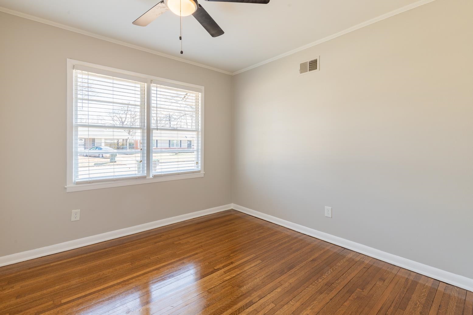 1511 Raymore Road Memphis, TN 38117 - Photo 14 of 21 wooden floor in an empty room with a window