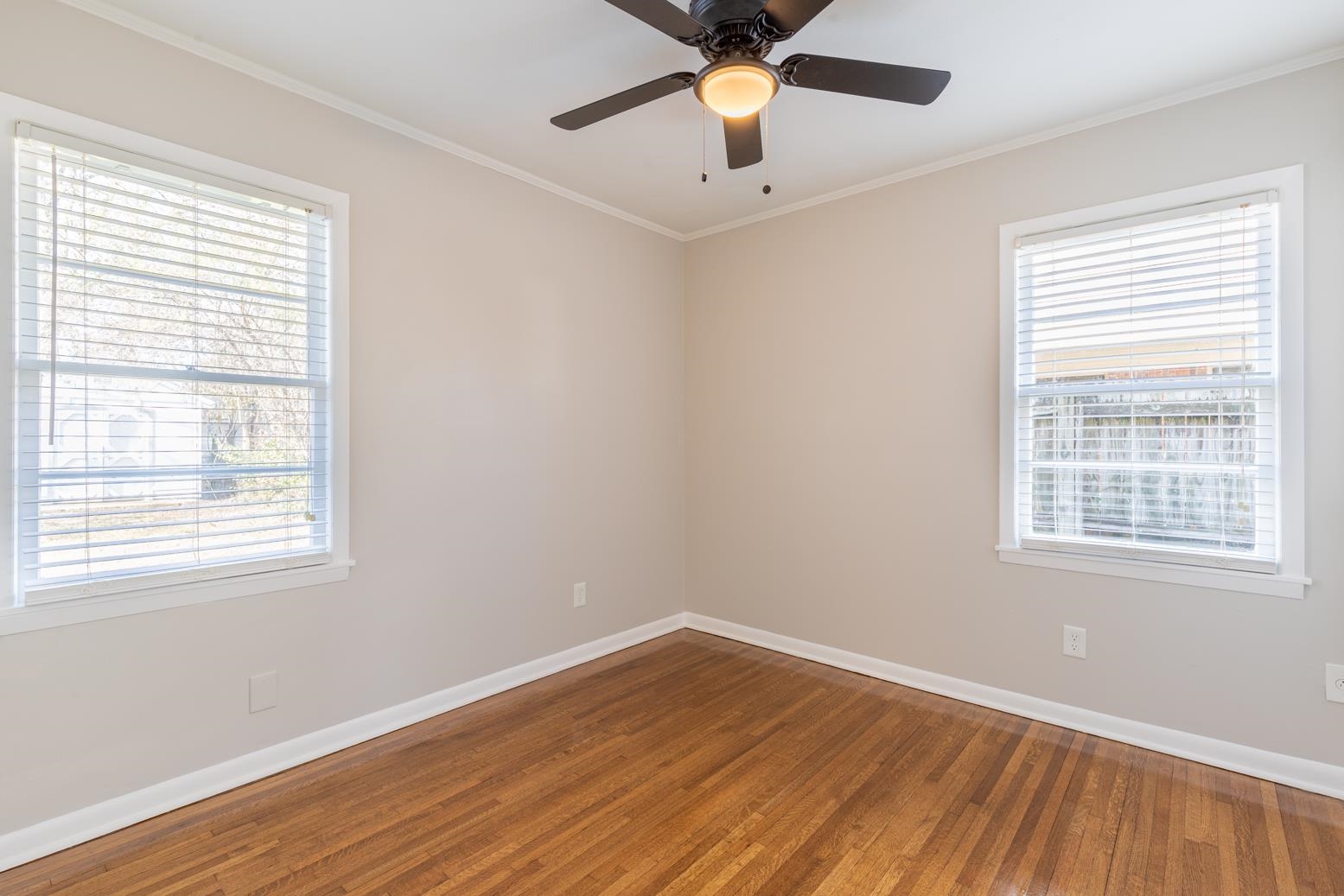 1511 Raymore Road Memphis, TN 38117 - Photo 16 of 21 a view of an empty room with wooden floor and a window