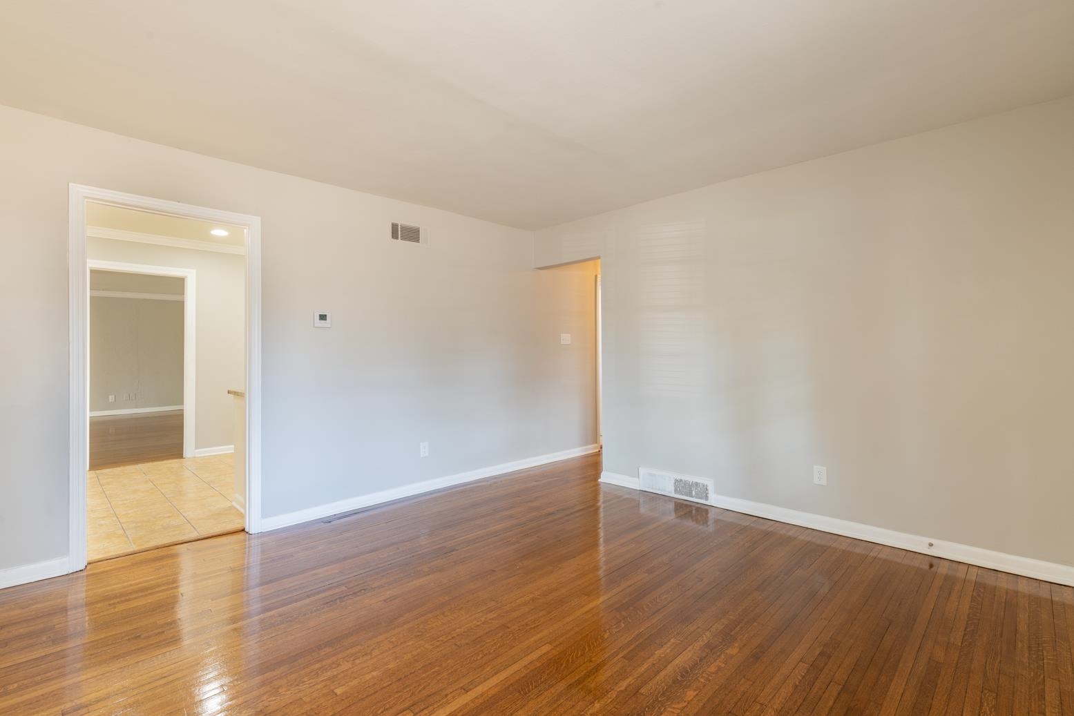 1511 Raymore Road Memphis, TN 38117 - Photo 7 of 21 a view of an empty room with wooden floor