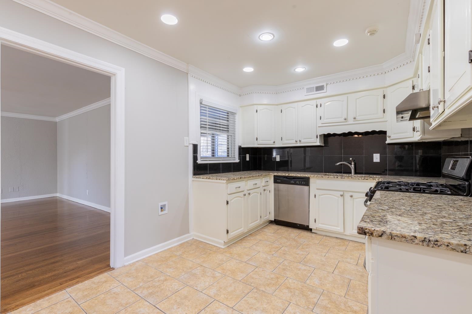 1511 Raymore Road Memphis, TN 38117 - Photo 8 of 21 a kitchen with stainless steel appliances granite countertop a stove a sink and a refrigerator