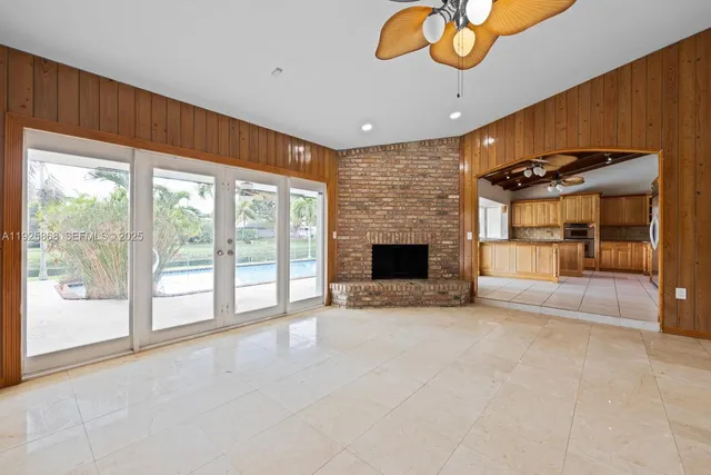 a view of kitchen with furniture and refrigerator