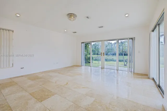 a view of an empty room with glass door