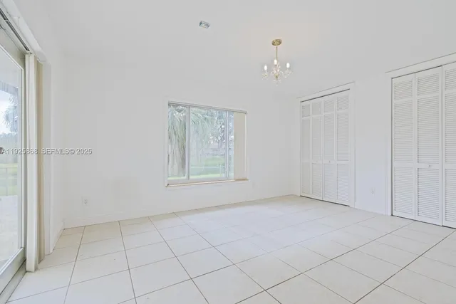 a bathroom with a bathtub a sink a vanity a lamp and a shower