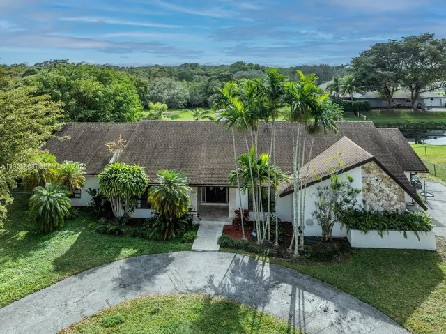 an aerial view of a house with a lake view