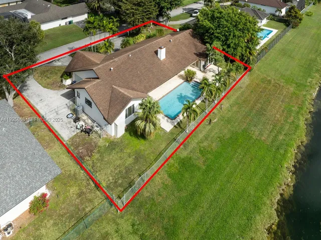 an aerial view of a house with a yard