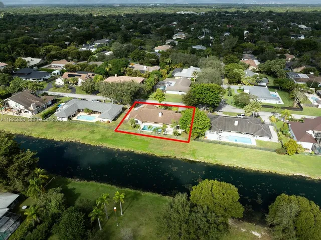 an aerial view of a house with a yard basket ball court and outdoor seating