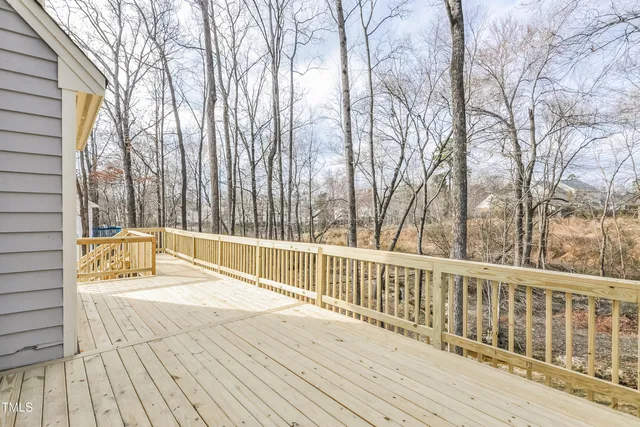 a view of balcony with wooden floor and fence