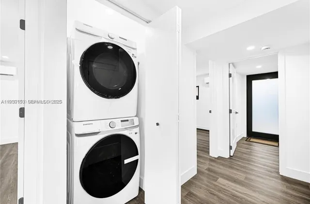 a view of a hallway with washer and dryer