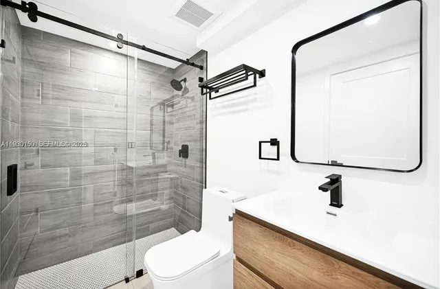 a bathroom with a sink toilet and shower