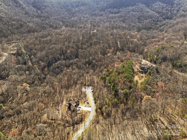 a view of a dry yard with mountains in the background