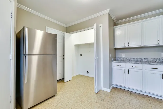 a view of kitchen with white cabinets