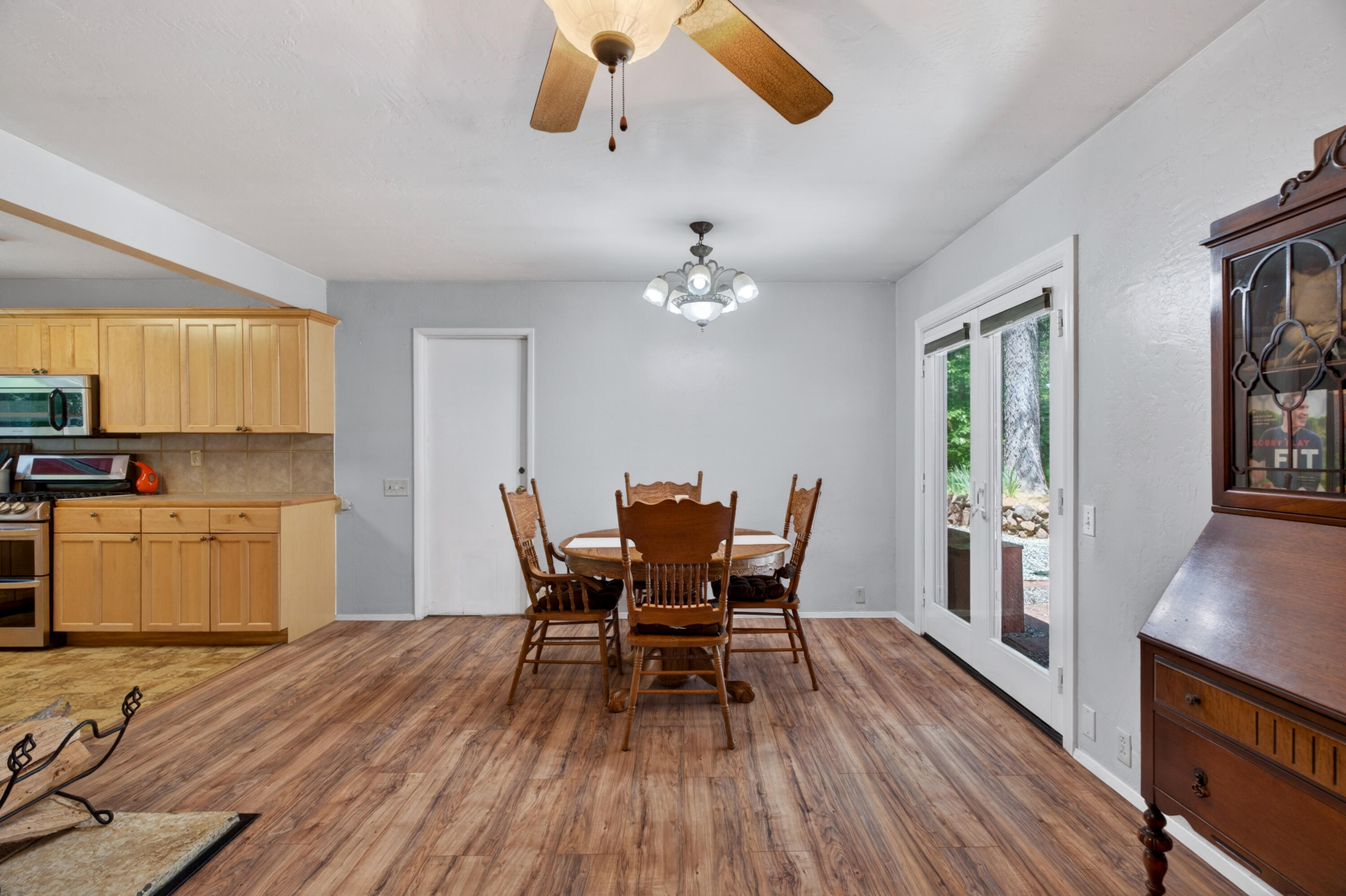 8015 Starlite Pines Road Shingletown, CA 96088 - Photo 15 of 38 a view of a dining room with furniture and wooden floor