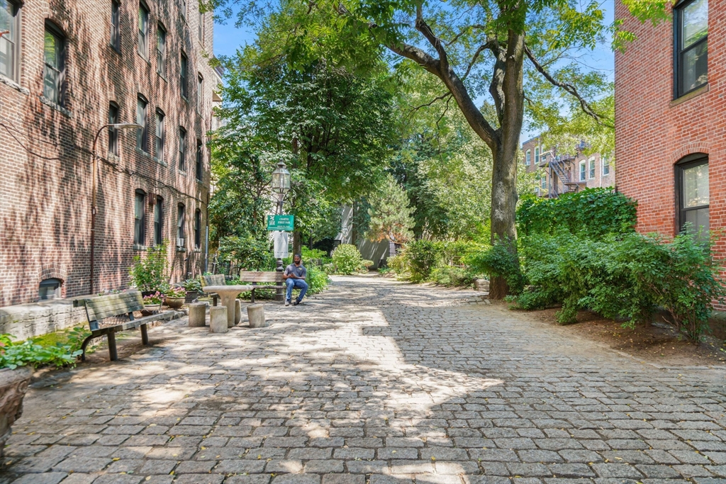 1 Unity Street, Unit 2F Boston, MA 02113 - Photo 16 of 16 a row of palm trees in front of a building