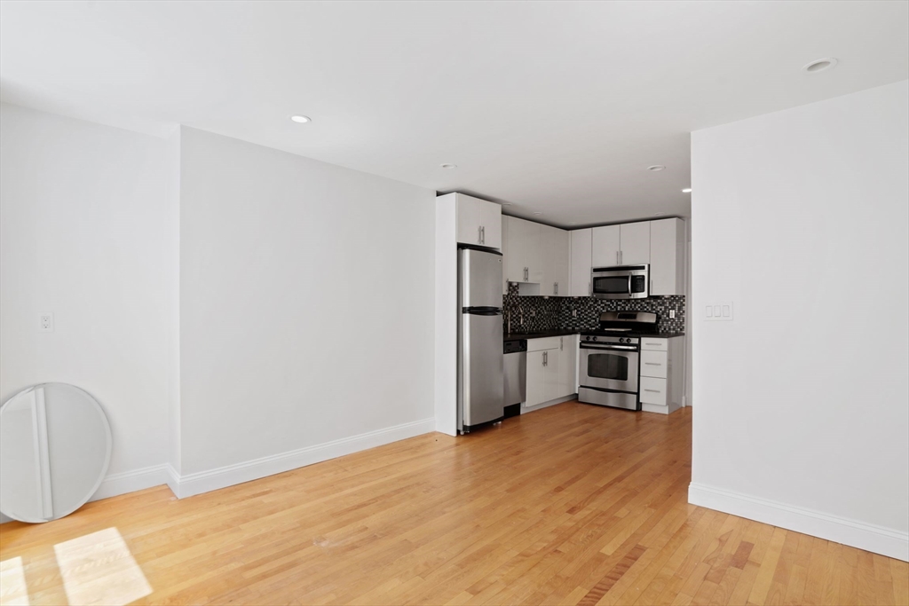 1 Unity Street, Unit 2F Boston, MA 02113 - Photo 4 of 16 a kitchen with stainless steel appliances a refrigerator and stove