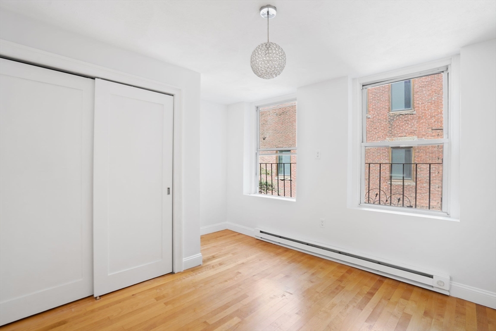 1 Unity Street, Unit 2F Boston, MA 02113 - Photo 9 of 16 a view of an empty room with wooden floor and a window
