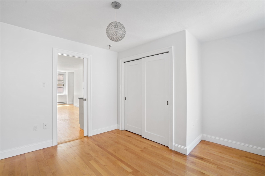 1 Unity Street, Unit 2F Boston, MA 02113 - Photo 10 of 16 a view of an empty room and wooden floor