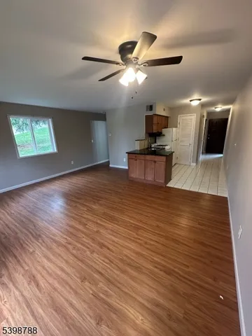 a living room with hard wood floors and a wooden floor
