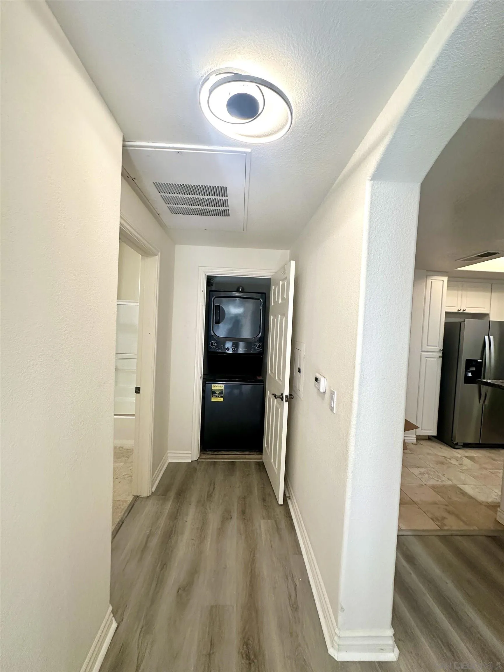 9263 Regents Road, Unit B204 La Jolla, CA 92037 - Photo 12 of 17 a view of a hallway view with wooden floor and staircase