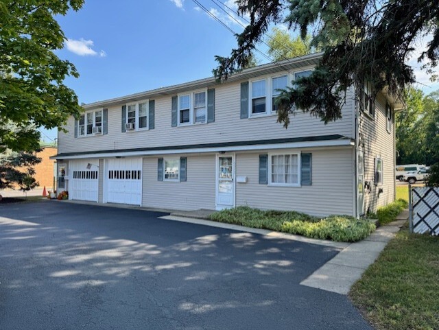 3311-3315 Waukegan Road McHenry, IL 60050 - Photo 1 of 16 a front view of a house with a yard and garage