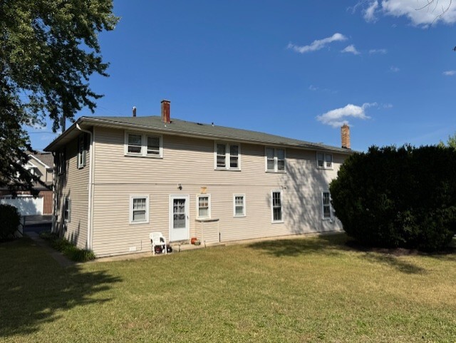3311-3315 Waukegan Road McHenry, IL 60050 - Photo 16 of 16 a view of a white house with a big yard