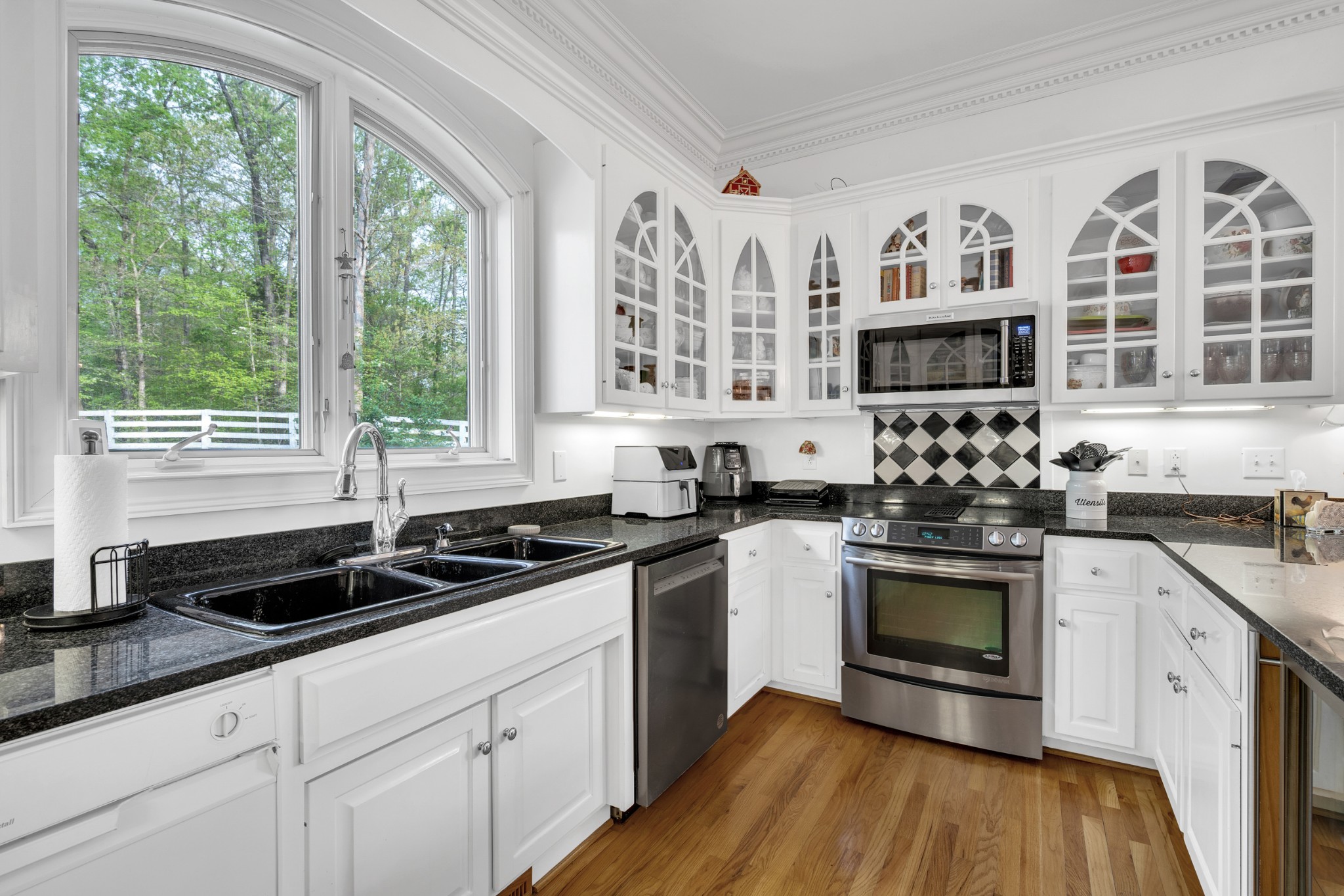 515 Cox Hollow Road Dover, TN 37058 - Photo 24 of 57 a kitchen with stainless steel appliances granite countertop white cabinets a window a sink and a stove