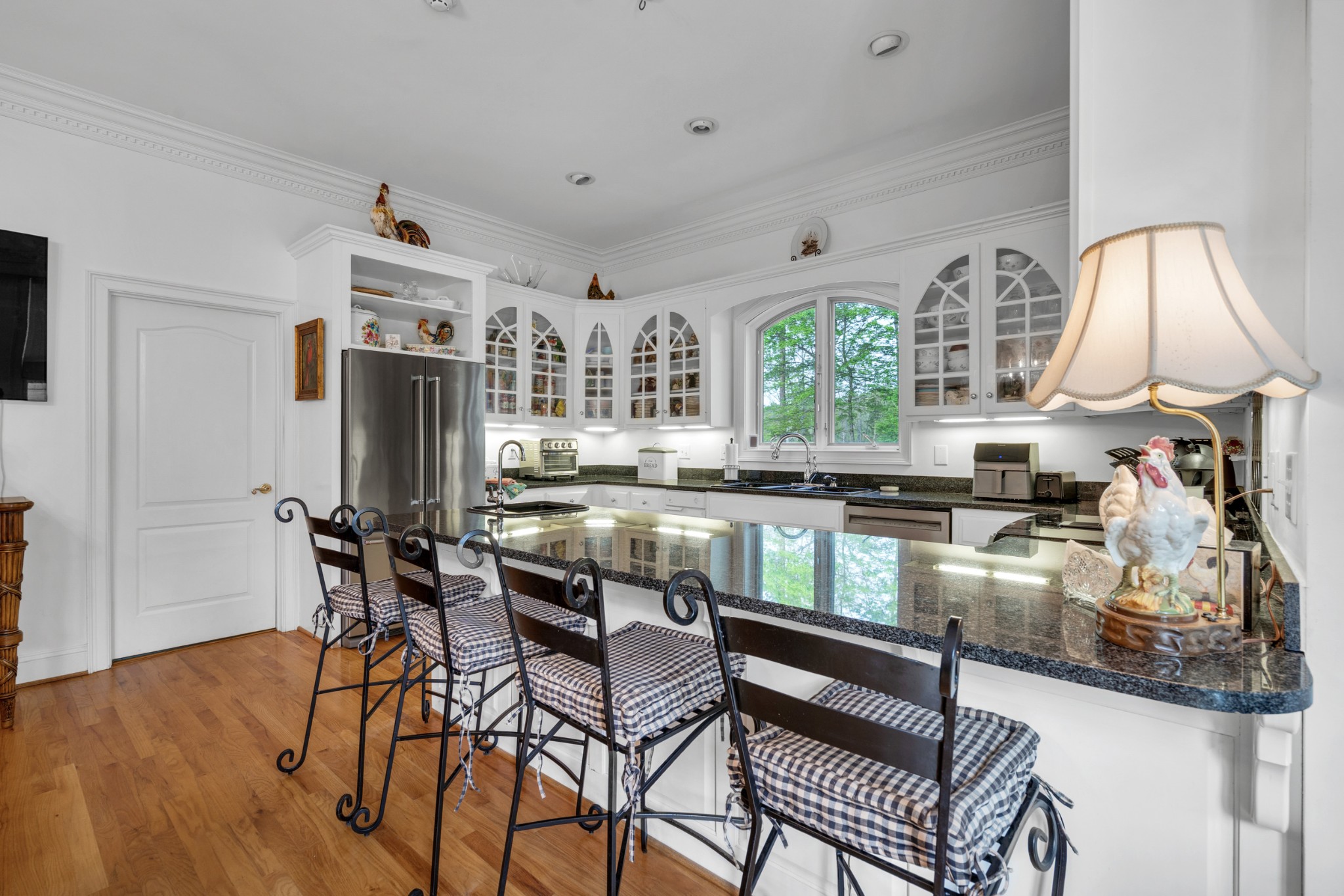 515 Cox Hollow Road Dover, TN 37058 - Photo 25 of 57 a kitchen with stainless steel appliances granite countertop a stove a sink dishwasher and a refrigerator with wooden floor