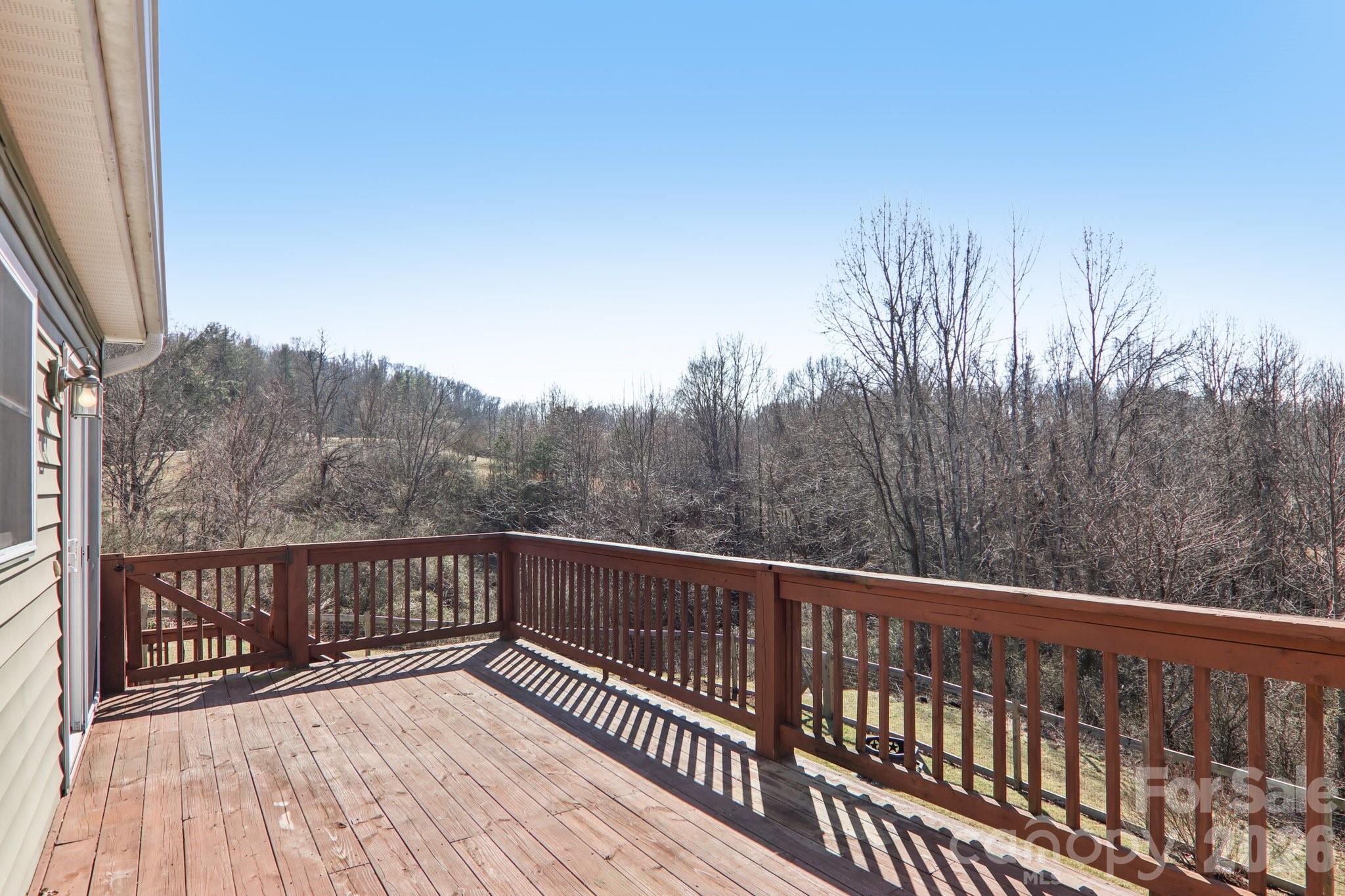 751 Hutch Mountain Road Fletcher, NC 28732 - Photo 37 of 48 a view of balcony with wooden floor and fence