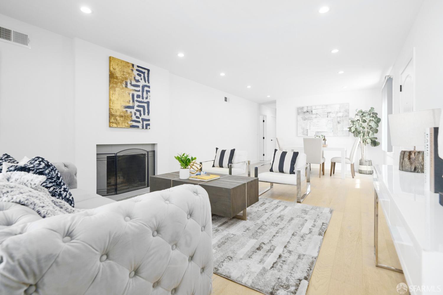 92 Oceanside Drive Daly City, CA 94015 - Photo 3 of 17 a living room with furniture a fireplace and a flat screen tv