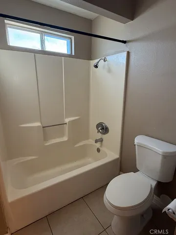 a bathroom with a toilet and a bathtub