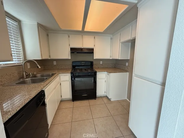 a kitchen with a sink stove and refrigerator