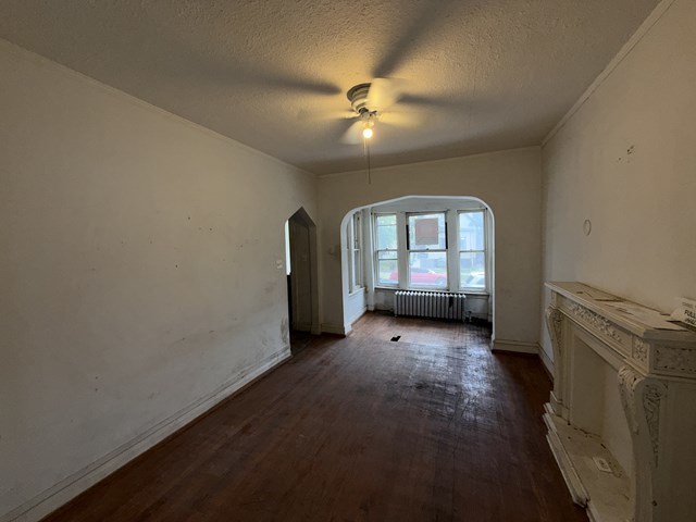 7514 South Rhodes Avenue Chicago, IL 60619 - Photo 4 of 11 an empty room with chandelier fan and windows