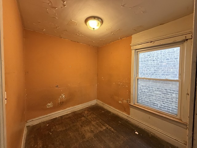 7514 South Rhodes Avenue Chicago, IL 60619 - Photo 8 of 11 a view of an empty room with a window